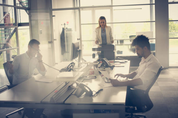 istock Business people working in office. African man typing on laptop. 831618034