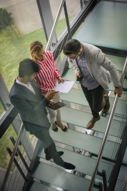 istock Business people using digital tablet in building office. Business people reading document. 831618596