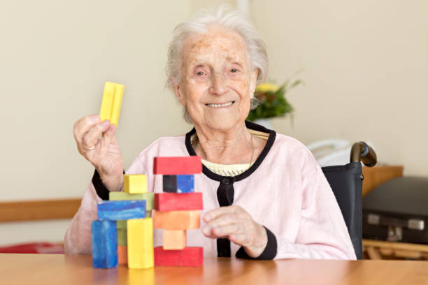 istock Senior woman playing with wooden blocks 831621742
