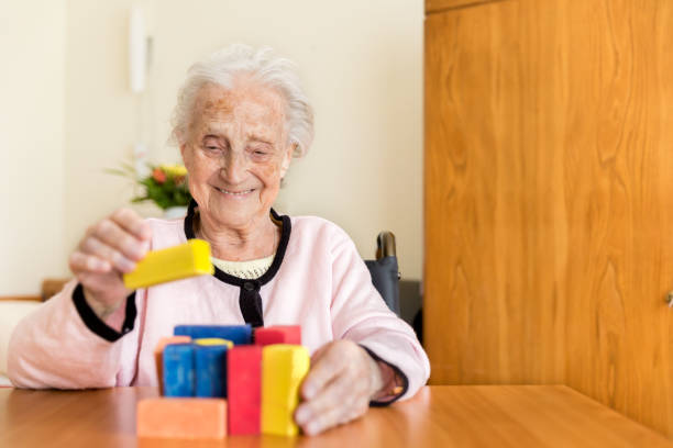 istock Senior woman playing with wooden blocks 831621766