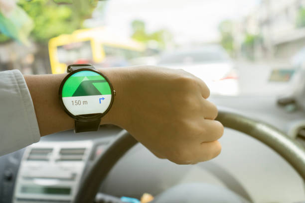 istock Close up of man in car on road watching smartwatch and using application navigation map to destination 831622470