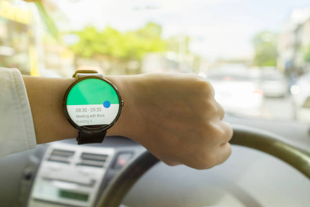 istock Close up of man in car on road watching smartwatch and using application navigation map to destination 831622590