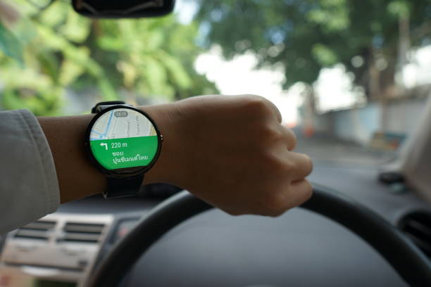 istock Close up of man in car on road watching smartwatch and using application navigation map to destination 831622716
