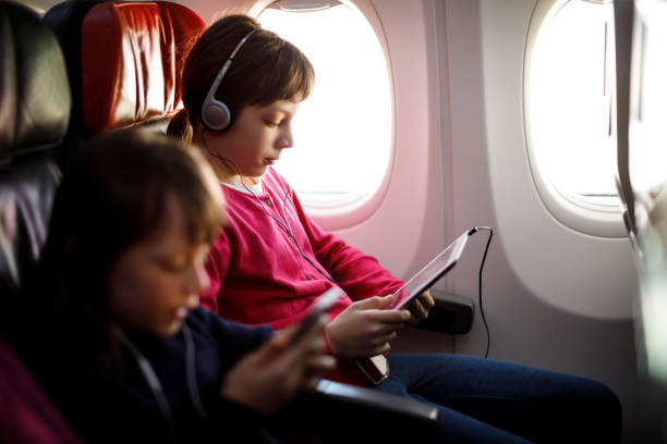 istock Airplane passenger using smart phone and digital tablet on the plane 831624178