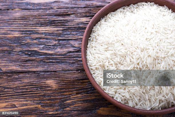 Uncooked Rice In A Bowl Stock Photo - Download Image Now - Asia, Backgrounds, Basmati Rice