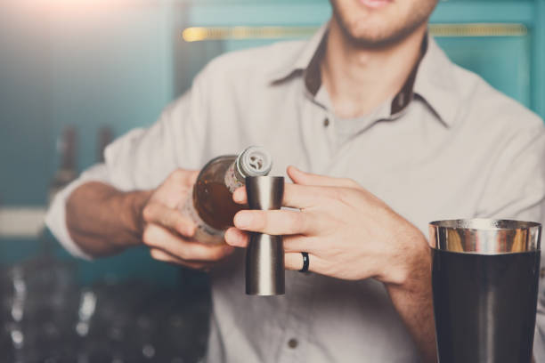 istock Bartender pouring syrup into measuring glass 831626250
