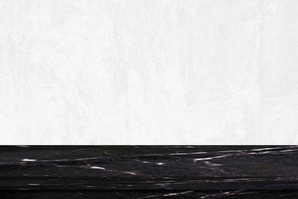 istock Empty black marble table over white cement wall background, product display montage 831626994