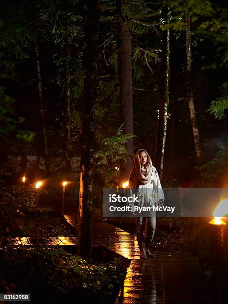 Woman Walking Along Rainy Pathway At Night Stock Photo - Download Image Now - Walking, Rain, Forest