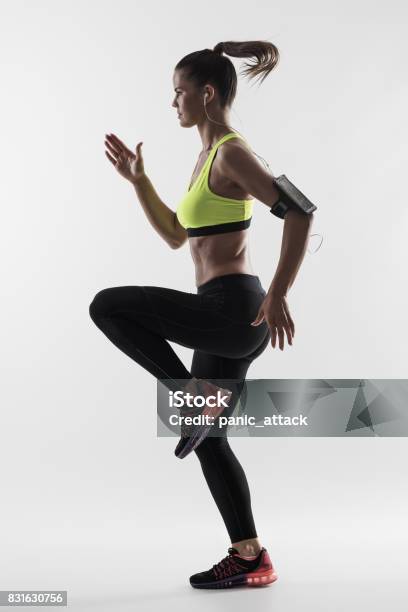 Desaturated Back Lit Silhouette Of Athletic Woman Runner Motion While Sprinting Fast Stock Photo - Download Image Now