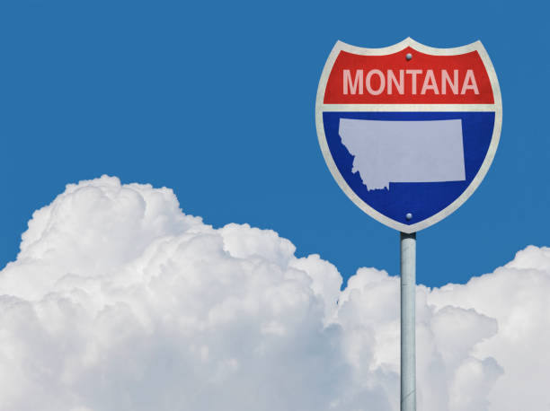 istock Highway sign for Interstate road in Montana with map in front of clouds 831631722