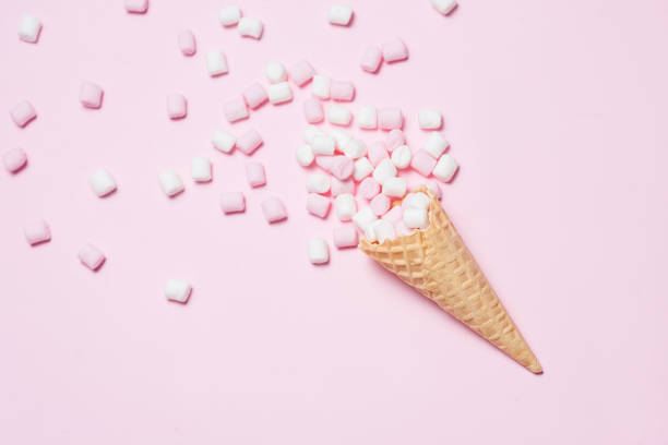 istock Pink and white Marshmallows in waffle cone on pink background. Top view, flat lay. free space for your text 831631974