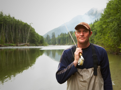Fisherman with a wild silver salmon on the Blind River, Petersburg, Alaska