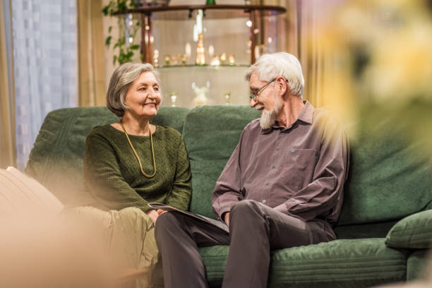 istock Senior couple sitting on sofa 831635112