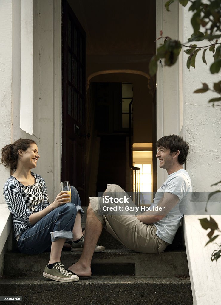 Couple laughing by the front stairs  Staircase Stock Photo