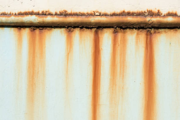 close-up view of old rusty pipe on wall background
