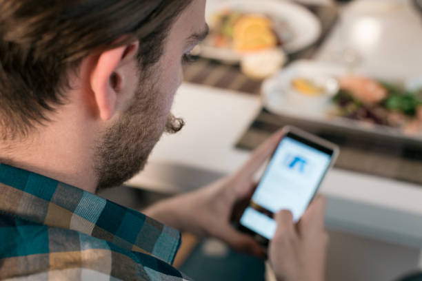 istock Man browsing social networks on smartphone in restaurant 831638698