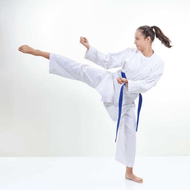 istock Young sportswoman strikes with a kick 831639770