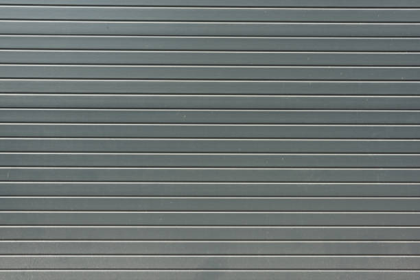 istock grey striped metal bling wall textured background 831639780