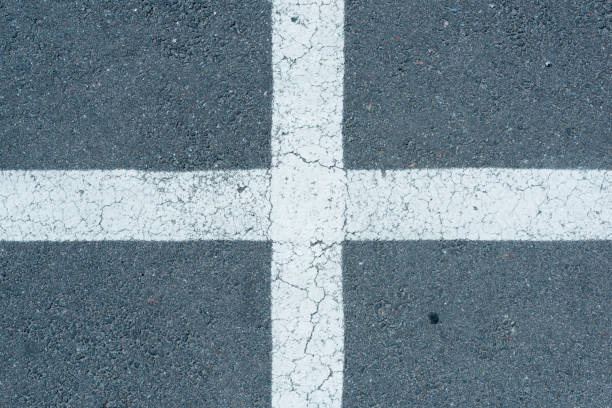 istock top view of white parking lines on grey roadway background 831640040