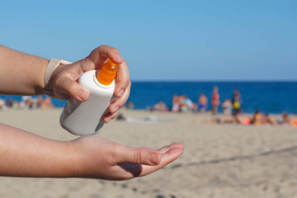 istock Woman hands putting sunscreen in the beach 831640652