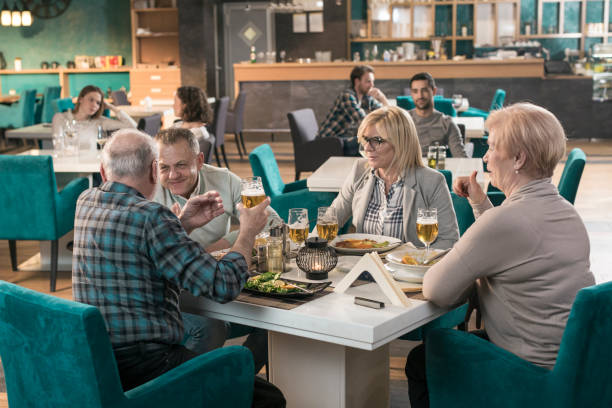 istock Mature friends in restaurant 831640698