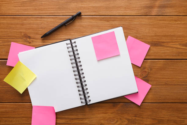 istock Top view of blank notepad on wooden office desk 831642550