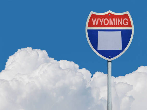 istock Highway sign for Interstate road in Wyoming with map in front of clouds 831643502