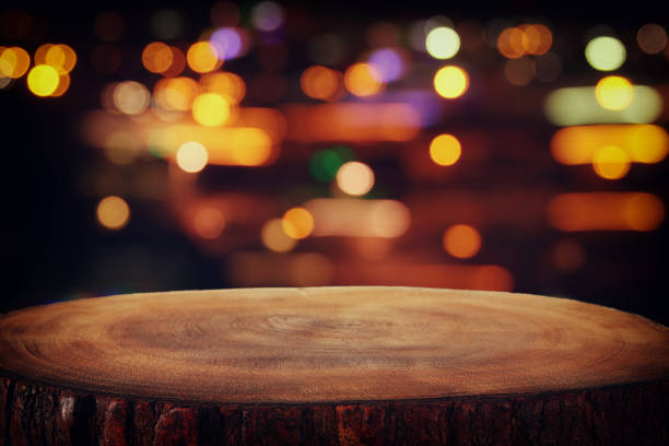 istock Image of wooden table in front of abstract blurred restaurant lights background. 831644340