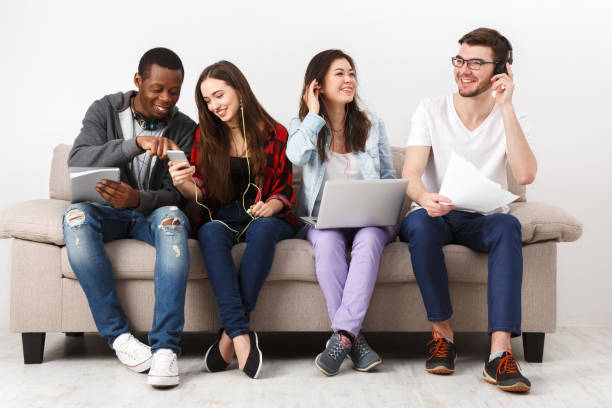 istock Young diverse people listen to music with gadgets 831647584