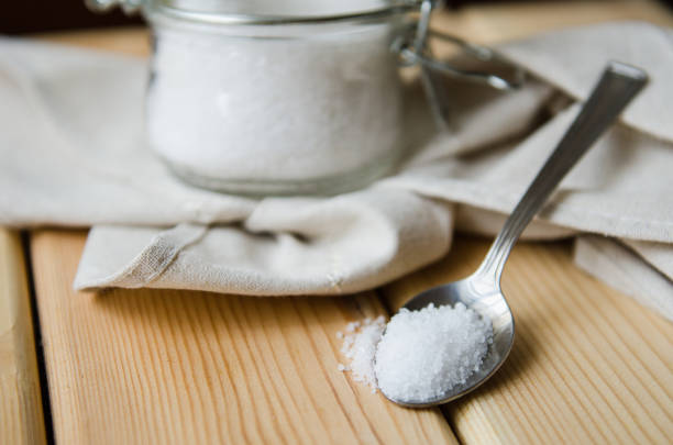istock White sea salt white napkin in a jar on an iron spoon 831647818