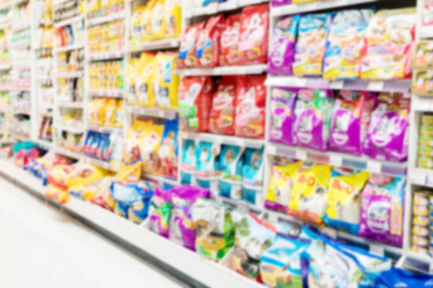 blurry background of animal feed product department in supermarket. - department store imagens e fotografias de stock