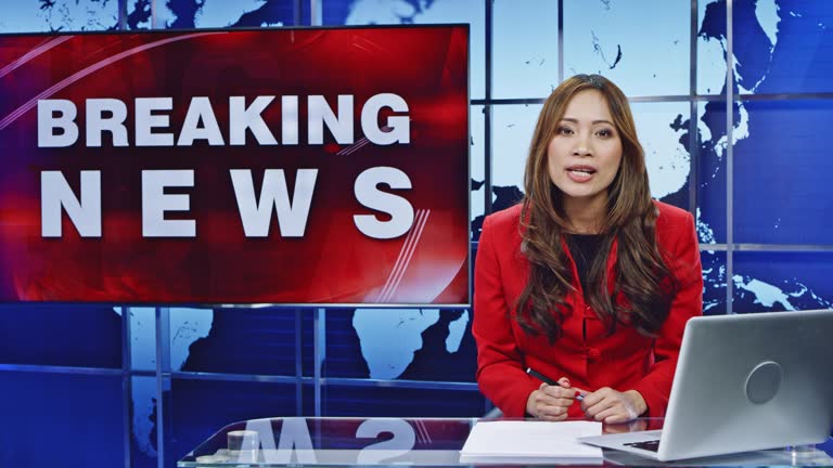 LD Asian female anchor presenting breaking news