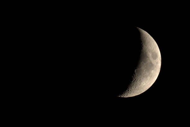 istock Waxing crescent moon seen with telescope 831648966