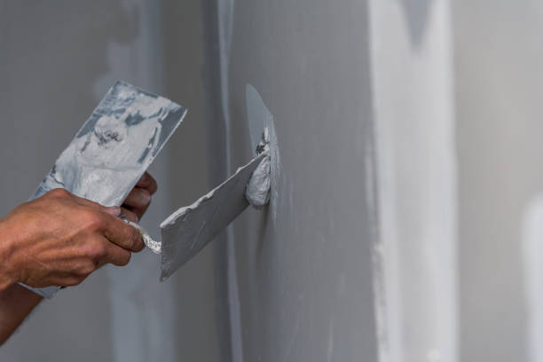 istock old manual worker with wall plastering tools renovating house 831652758