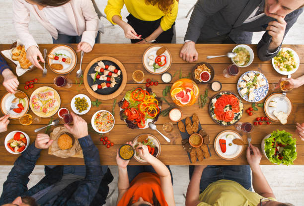 istock People eat healthy meals at served table dinner party 831653504