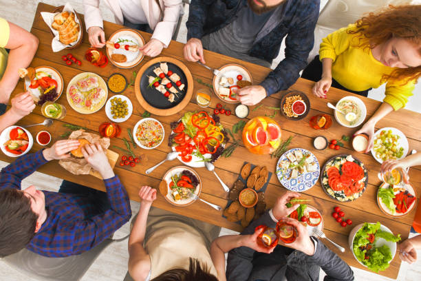 istock People eat healthy meals at served table dinner party 831653554
