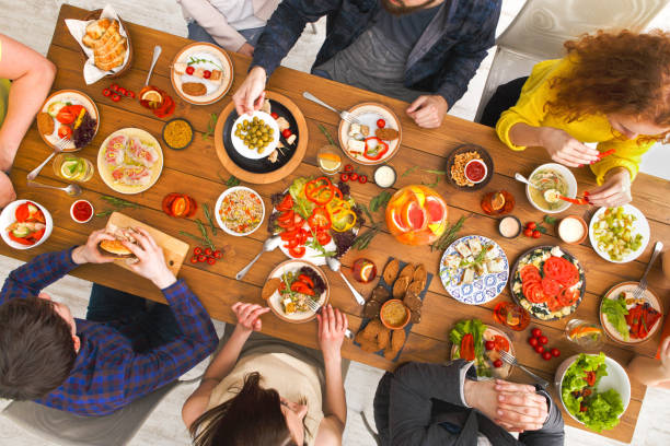 istock People eat healthy meals at served table dinner party 831653630