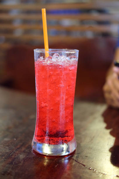 istock Close up red lime soda on wood table 831656950