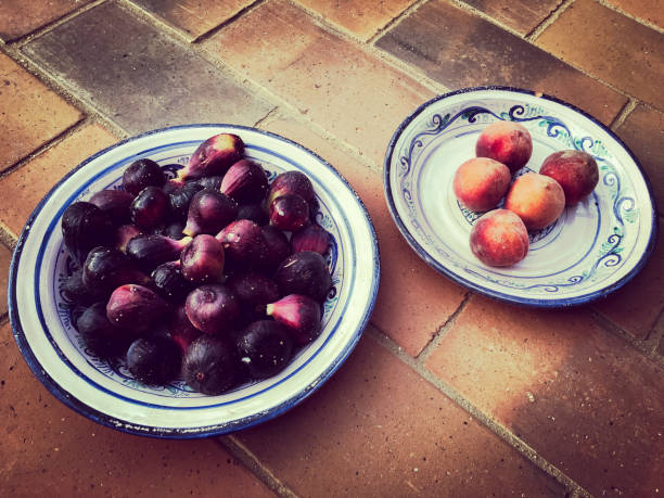 istock figs and peaches on antique plates 831657132
