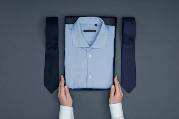 istock tailor with shirt in box and neckties 831659710