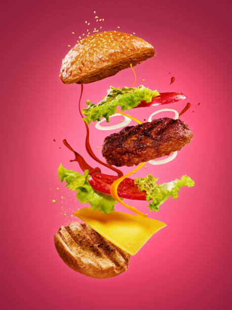 istock The hamburger with flying ingredients on rose background 831660710