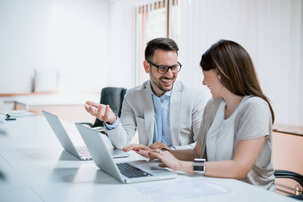 istock Young business team working together at a laptop smiling 831664668
