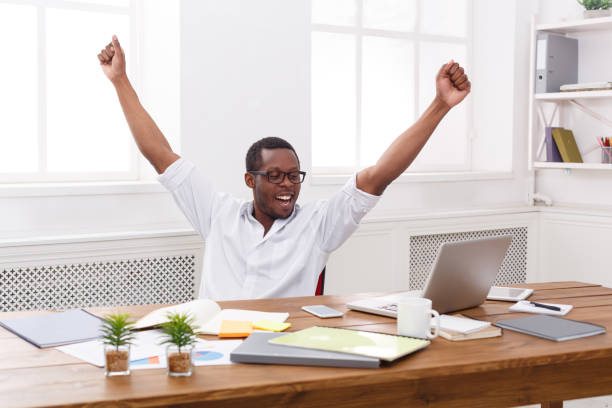 istock Happy businessman win. Winner, black man in office 831664688