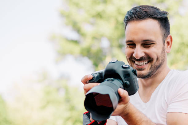 istock Man looking at photos he taken 831664904