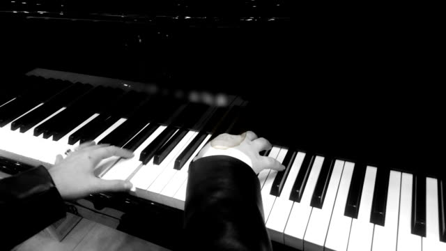 Hands of professional female musician playing melody on piano, retro effect