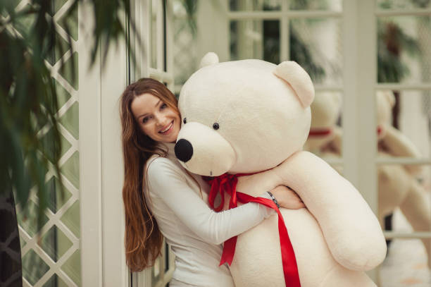 istock Beautiful girl holding a big white teddy bear 831668816