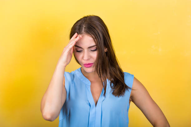 istock Pretty woman standing against bright background 831679738