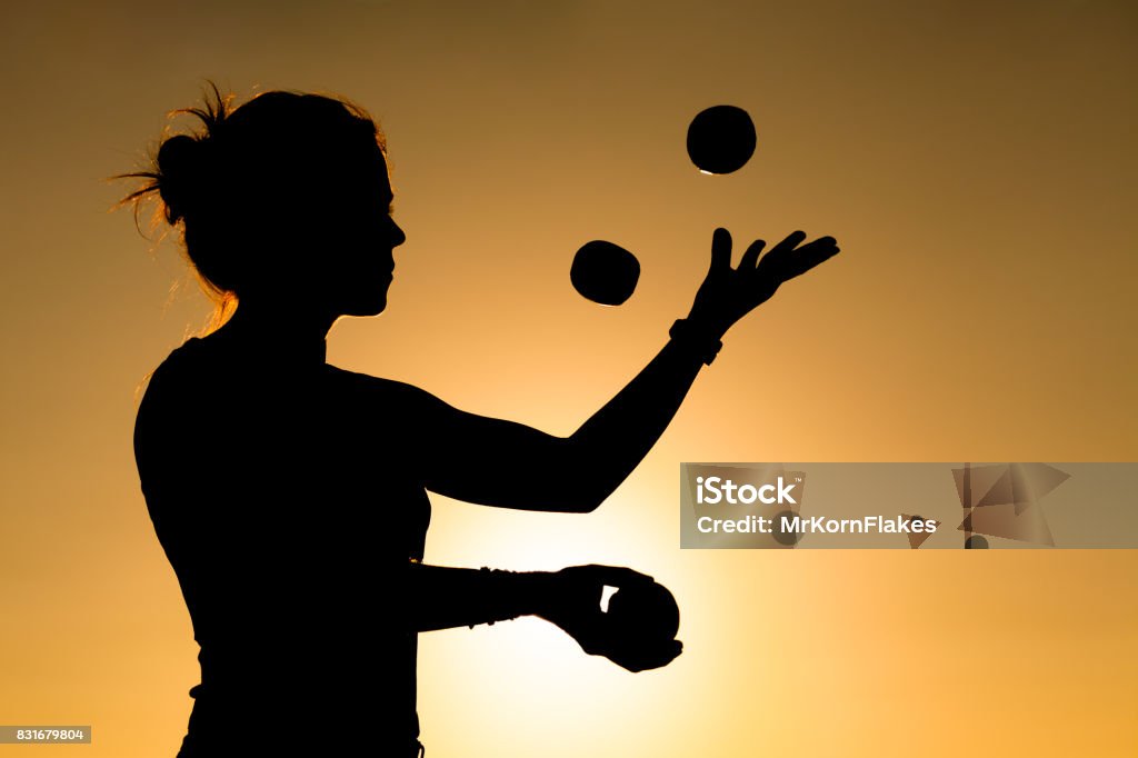 Woman Juggler Silhouette of a Woman Juggling with Balls at Sunset Juggling Stock Photo
