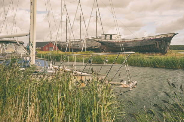 The old yacht in the Strait against the backdrop of ancient three-masted motor yacht on the Baltic sea on the island of Hiiuma