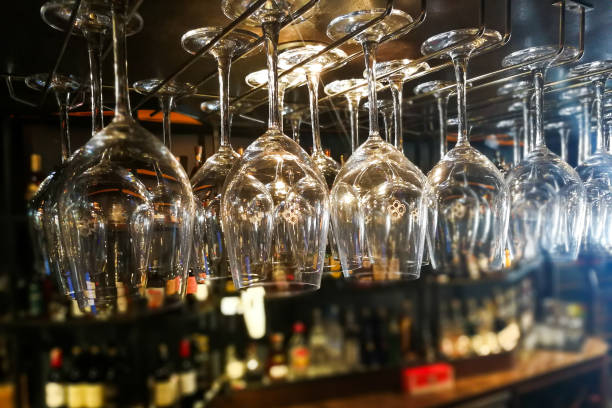 istock Empty wine glasses hanging on rack in bar 831689078